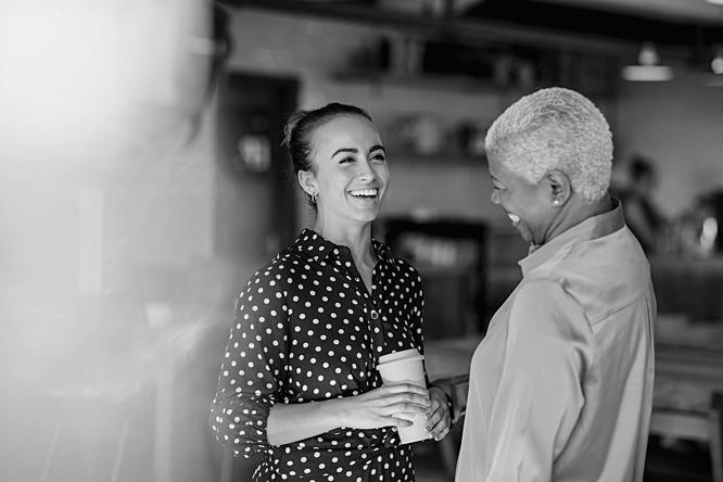 black and white image of two woman smiling and laughing